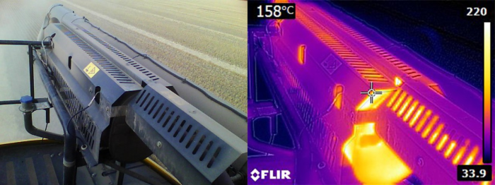 Image of harvester exhaust covering glowing red from heat, using infrared camera to demonstrating temperature of 158 degrees celsius 