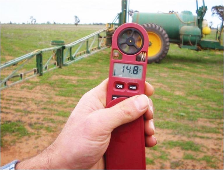 An image of a hand holding a weather meter.