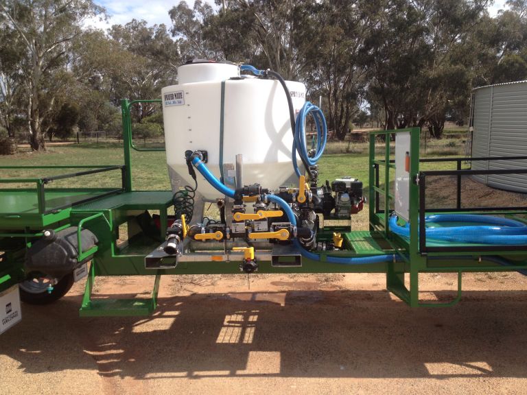 An image of a chemical mixing vat mounted on a spray trailer.