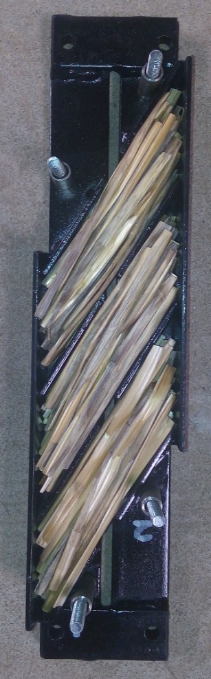 This is a photo showing the bottom sections of the holding tray which  are designed to locate the straw stem axes at 30 degrees.