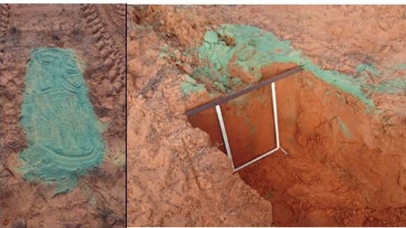 Blue sand applied to the surface to validate soil burial behind inclusion plates.