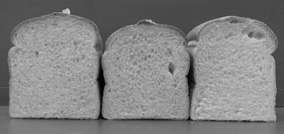 Three different bread loaves, exposed slice showing.