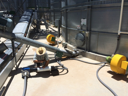Figure 4. Philip Burrill (DAF Qld) measuring air-flow in the recirculation system. For easy to follow details on how to measure air-flow in silos see http://storedgrain.com.au/testing-aeration/